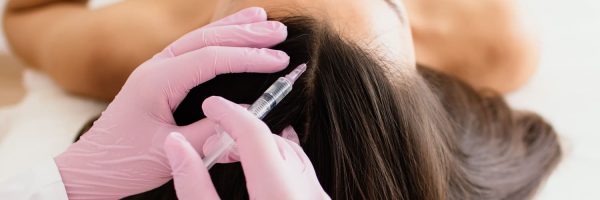 hair treatment in cosmetology using mesotherapy. injection to the head. selective focus